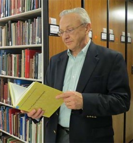 Walter Cybulski looks at a book