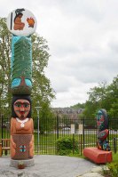 A tall totem pole and a smaller totem bench.