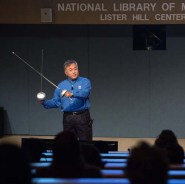 Dr. Yoo holds two fencing swords