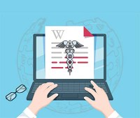 a person types on a laptop on which is visible a page showing the Wikipedia "W" and the medical caduceus symbol